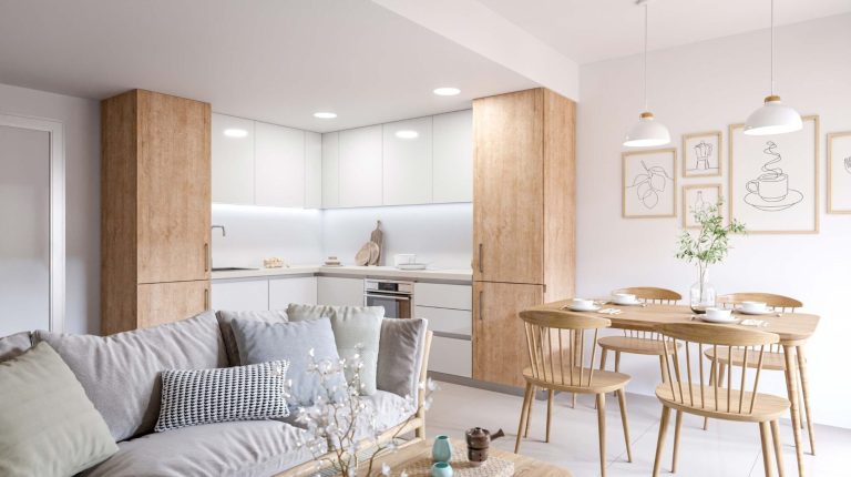 Cocina moderna y luminosa con muebles de madera, comedor y área de estar acogedora.